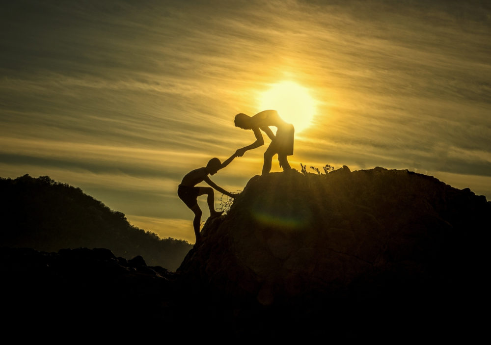 climbers helping each other while facing challenges